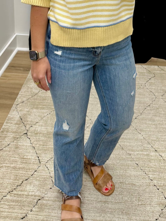 THE CALI DISTRESSED KICK FLARE CROP DENIM